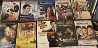 Photo of 10 assorted DVDs laid out in two rows showing the front cover art and titles