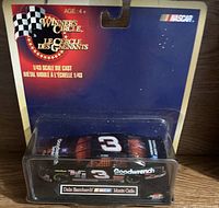 Sealed 1:43 scale NASCAR die cast car featuring Dale Earnhardt with black Goodwrench livery in original blue and red Winner's Circle packaging.