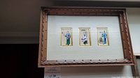 Full front view of the framed set showing the three rice paper pith paintings and carved wooden frame.