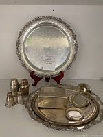 Full set displayed including silver-plated serving trays, Birks sterling trinket box, and two pairs of shakers.