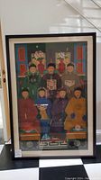Front view of framed portrait depicting seven dignitaries in traditional attire.