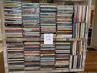 Acrylic shelving unit filled with multiple columns of CD jewel cases