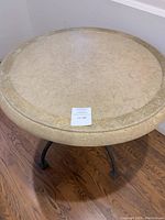 Top view of round stone tabletop showing color, texture, and approximate diameter