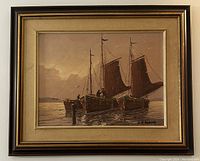 Framed oil painting showing three wooden sailboats on water at sunset or dusk, signed lower right.