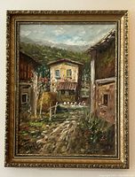 Framed oil painting showing the entire artwork with visible dirt path, buildings, birds and sky, within an ornate antique gold frame