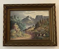 Full view of the framed oil painting showing the mountain landscape and pathway with visible artist signature