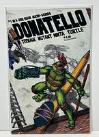 Front cover of Donatello: Teenage Mutant Ninja Turtle #1 comic book in protective bag and board, showing the character Donatello in action and series title.
