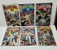 Six Marvel Secret Wars II comic issues displayed together, showing front covers with vibrant character artwork.