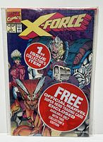 Front cover of Marvel X-Force #1 comic book showing the title, characters and promotional stickers indicating key issue status and free trading card.