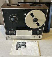 Front view of the vintage Sony Stereo Tape Recorder TC-355 with manual and carry handle visible.