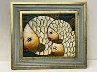 Full view of framed oil painting showing three fish with white scales and orange faces.