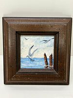 Full view of vintage oil painting of seagulls over ocean with wooden frame