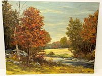 Full view of the signed oil painting on canvas showing a landscape with trees, a river, and a field in autumn colors.