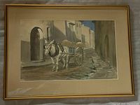 Full view of the framed watercolor painting showing the donkey cart scene