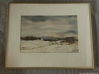 Framed watercolour landscape painting showing snowy fields, bare trees, and distant barns under a cloudy sky.
