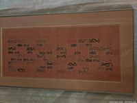 Full view of the framed ink drawing on a reddish-brown background with multiple abstract figures.