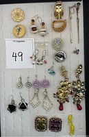 Full view of assorted earrings on display card showing variety of styles and materials including Sara Coventry, 925 silver, and costume pieces