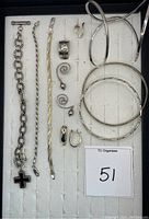 Full lot view showing various bracelets, earrings, and rings in organizer tray.