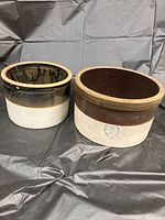 Both ceramic crocks side by side showing size and color differences.