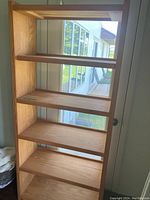Front view of the five shelf solid wood bookcase showing the flat shelves and wood grain finish.