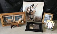 Photo showing five items including mounted horse canvas, framed photo of girl and horse, two rooster-themed frames (one wooden, one ceramic), and a cardboard frame with scenic photo placeholder.