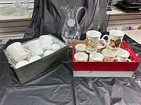 Overall view of all mugs and glass pitcher in containers