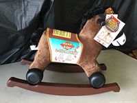 Full side view of the Rockin' Rider 2-in-1 Pony plush toy in rocker mode.
