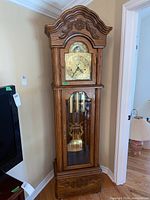 Full view of the Salem grandfather clock, showing the wooden case, crown molding, clock face, and glass door with pendulum inside.