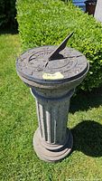 Front view of sundial on fluted pedestal