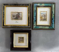 Three framed 925 sterling silver leaf foil miniature artworks on a gray surface.