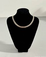 Front view of 16 inch silver necklace displayed on black bust form showing chain link design.