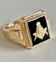 Front-right three-quarter view showing black inset and Masonic emblem