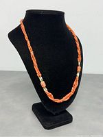 Necklace draped on black bust to display overall length and design