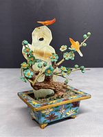 Front and side view of the jade bonsai tree with two orange birds and green floral buds, seated in blue cloisonne pot with floral decoration.
