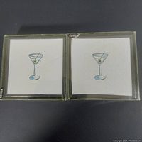 Two Danica brand square coasters showing the martini glass design, side-by-side.
