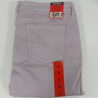 Folded lavender denim pants showing back pocket and size tag 8 and product label