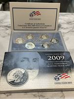 Proof set in original packaging showing face of George Washington and United States Mint logo with certificate of authenticity above coins.
