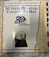 Photo of the front cover of the 50 State Quarters Collector's Map featuring the eagle and official title.