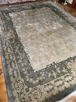 Full view of Expo Rivera 9x12 rug lying flat showing central field and surrounding floral geometric border.