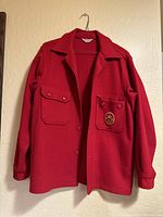 Front view of vintage red wool Boy Scouts of America jacket showing collar, button closure, and pockets.