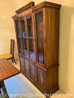 Front view of walnut china hutch with glass doors and cabinet decals