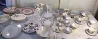 Top view of the collection showing a variety of plates, bowls, pitchers, and cups with floral and decorative designs.