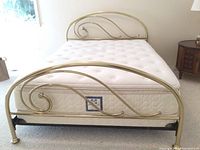 Close up photo of footboard curved swirls and metal framing