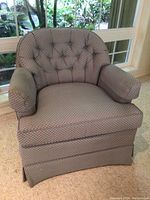 Front view of the Drexel armchair showing blue diamond patterned fabric, tufted backrest, padded armrests, and skirted base.