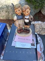Pair of children figurine on black box with certificate