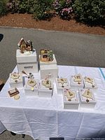 Photo of figurines and ornaments displayed on white cloth with original boxes visible
