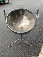Front view of steel drum pan on tripod stand with mallets