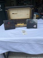 Vintage Grundig Model 960 radio with two CD covers, one for Andrew Lloyd Webber set and one for The Phantom of the Opera, displayed on white cloth.