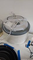 Full view of Nesco food and jerky dehydrator with power cord and main control dial, unit appears used and needs cleaning.