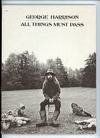Front cover of the songbook showing George Harrison sitting outdoors surrounded by gnomes.